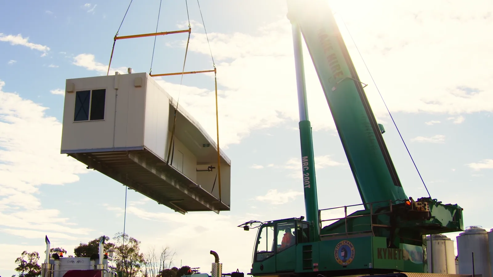 A McGregor multi-section portable building being craned into place on site